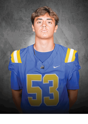 A young man wearing a white and black jersey with the number 14 on it. Description generated by AI