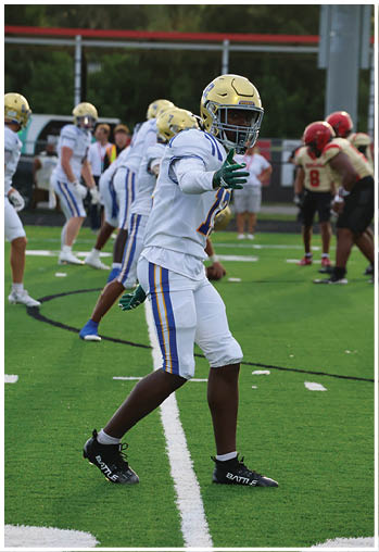 A football player running on the field. Description generated by AI