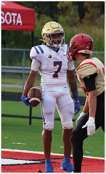 A football player running on the field. Description generated by AI