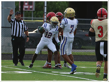 A football player is sliding on the ground. Description generated by AI