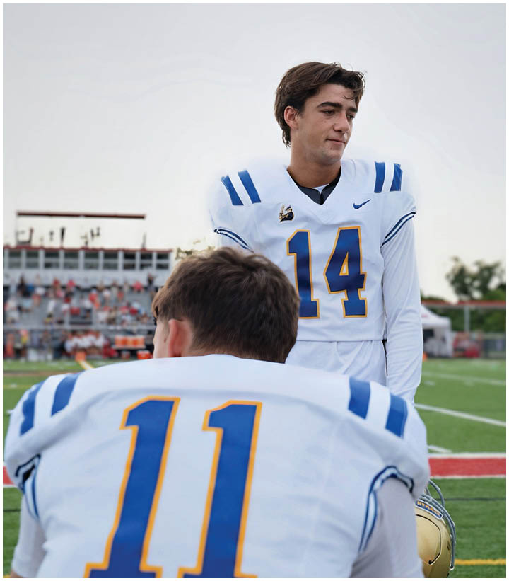 A group of football players wearing black and white uniforms. Description generated by AI