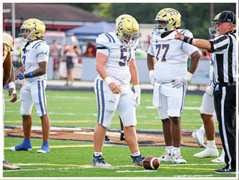 A football player is sliding on the ground. Description generated by AI