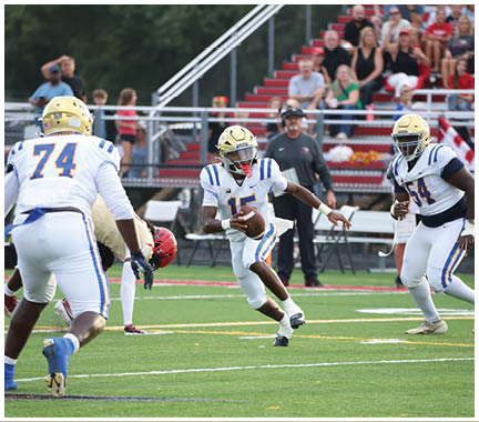 A football player wearing a blue and white uniform. Description generated by AI