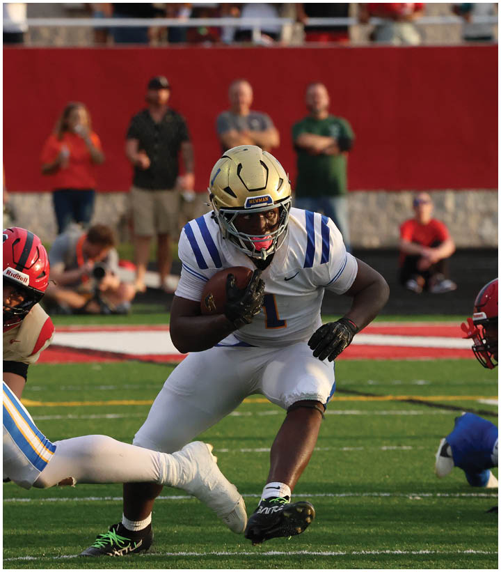A group of football players wearing black and white uniforms. Description generated by AI