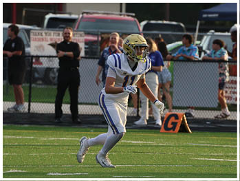 A football player is sliding on the ground. Description generated by AI