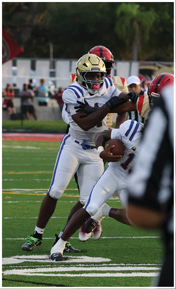 A football player running on the field. Description generated by AI