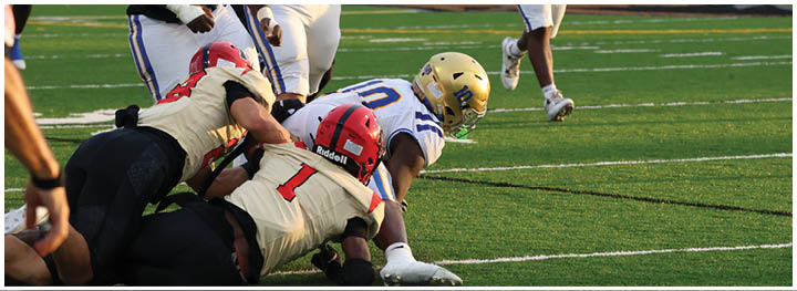 A football player is sliding on the ground. Description generated by AI