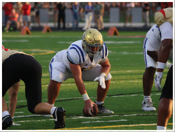 A football player is sliding on the ground. Description generated by AI