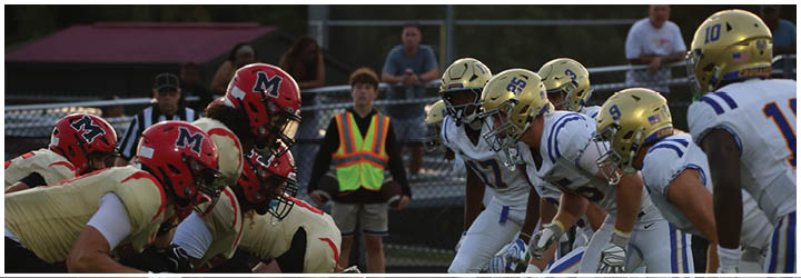 A group of football players on a field. Description generated by AI
