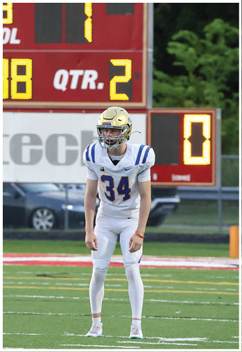 A football player running on the field. Description generated by AI