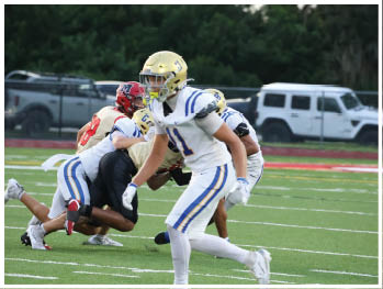 A football player is sliding on the ground. Description generated by AI