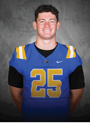A young man wearing a white and black jersey with the number 14 on it. Description generated by AI