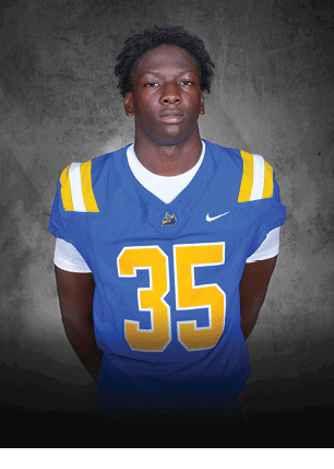 A young man wearing a white and black jersey with the number 14 on it. Description generated by AI