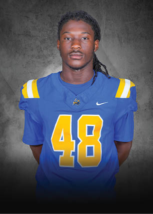 A young man wearing a white and black jersey with the number 14 on it. Description generated by AI