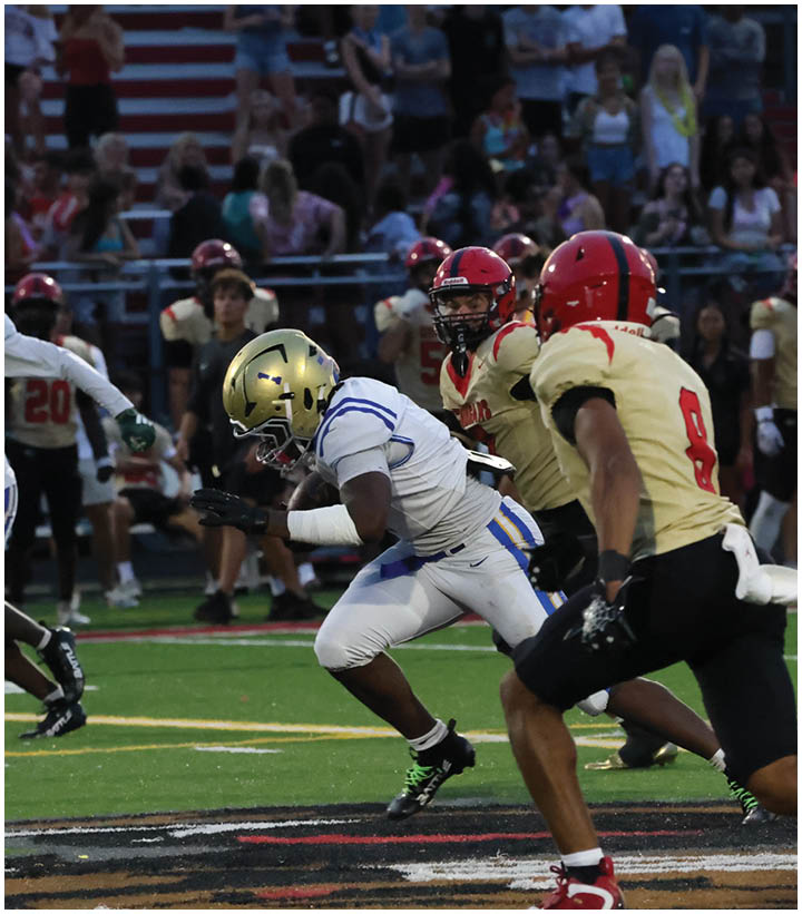 A group of football players wearing black and white uniforms. Description generated by AI
