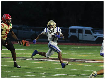 A football player is sliding on the ground. Description generated by AI