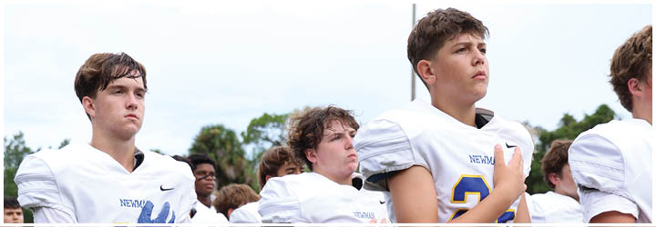 A group of football players on a field. Description generated by AI