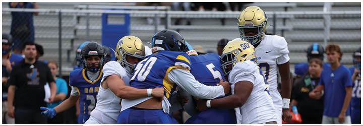 A group of football players on a field. Description generated by AI