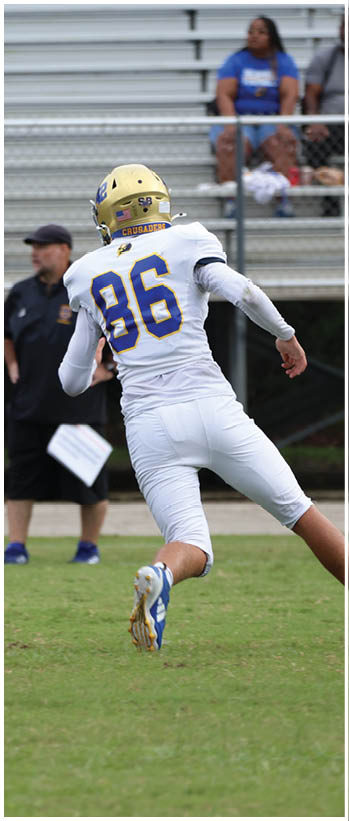 A football player running on the field. Description generated by AI