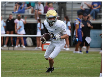 A football player is sliding on the ground. Description generated by AI