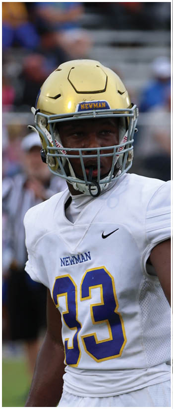 A football player running on the field. Description generated by AI