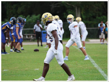 A football player is sliding on the ground. Description generated by AI