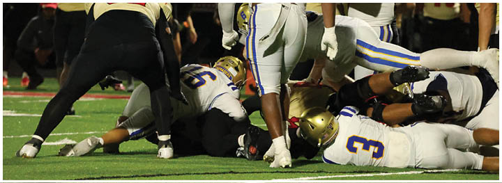 A football player is sliding on the ground. Description generated by AI