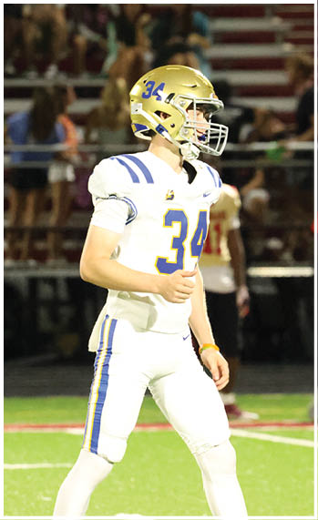 A football player running on the field. Description generated by AI