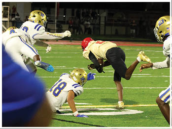 A football player is sliding on the ground. Description generated by AI
