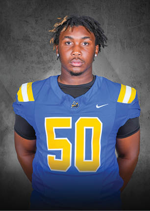 A young man wearing a white and black jersey with the number 14 on it. Description generated by AI