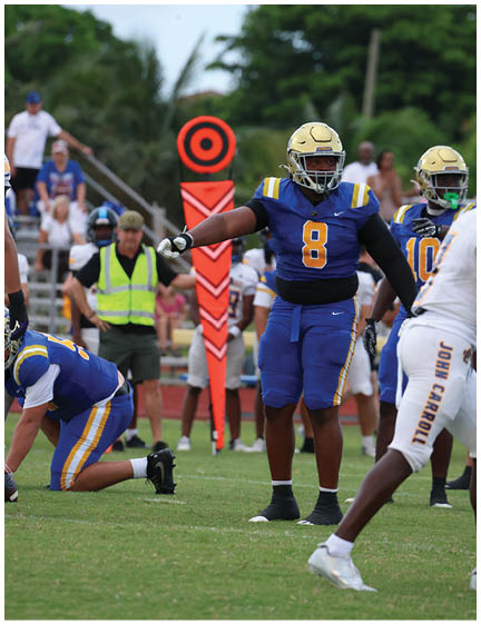A football player wearing a blue and white uniform. Description generated by AI