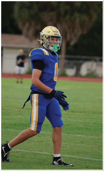 A football player running on the field. Description generated by AI