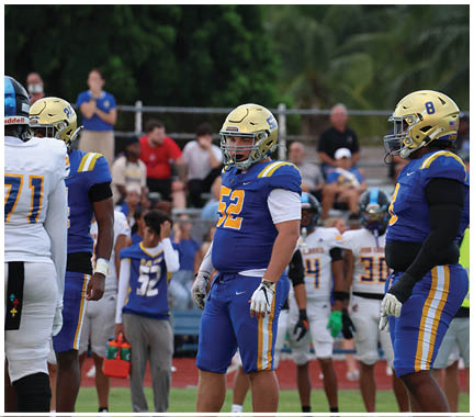 A football player wearing a blue and white uniform. Description generated by AI
