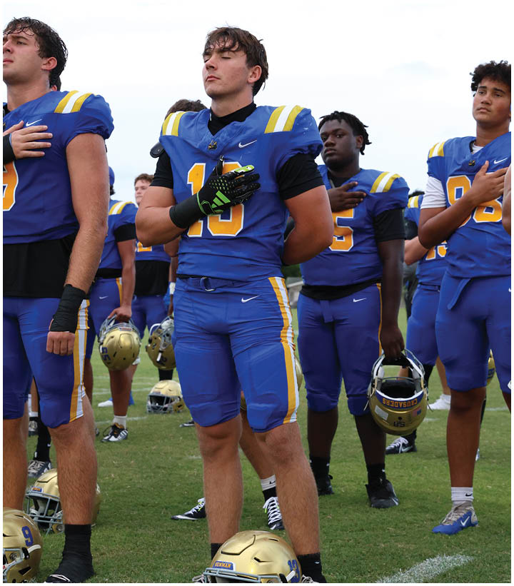 A group of football players wearing black and white uniforms. Description generated by AI