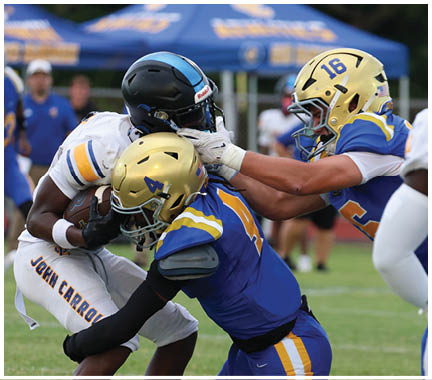 A football player wearing a blue and white uniform. Description generated by AI
