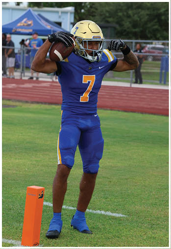 A football player running on the field. Description generated by AI