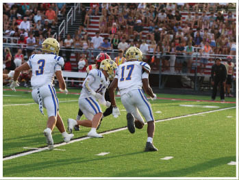 A football player is sliding on the ground. Description generated by AI