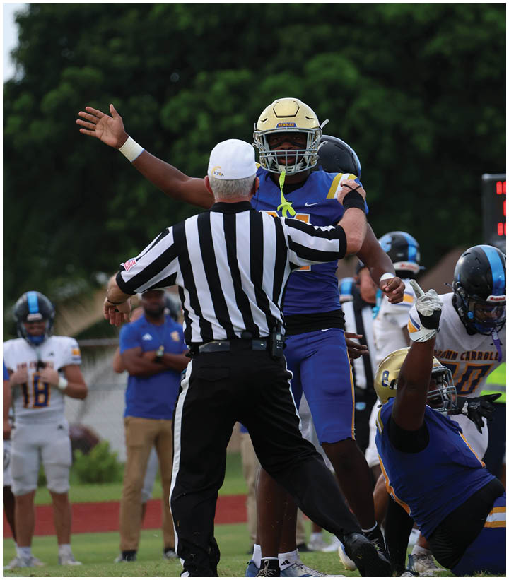 A group of football players wearing black and white uniforms. Description generated by AI