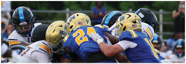 A group of football players on a field. Description generated by AI