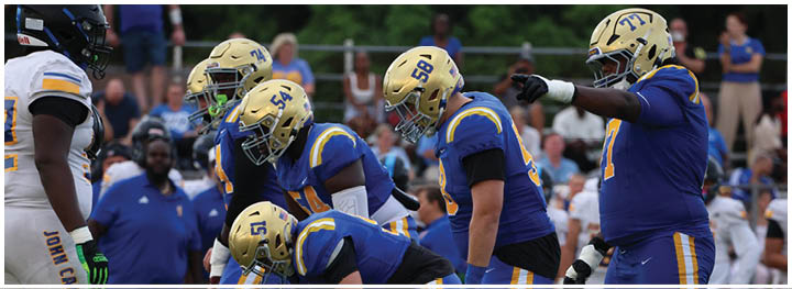 A football player is sliding on the ground. Description generated by AI