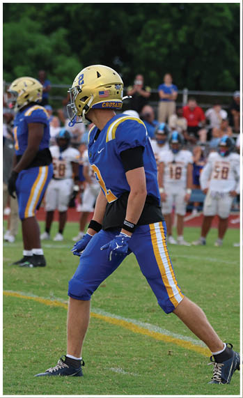 A football player running on the field. Description generated by AI