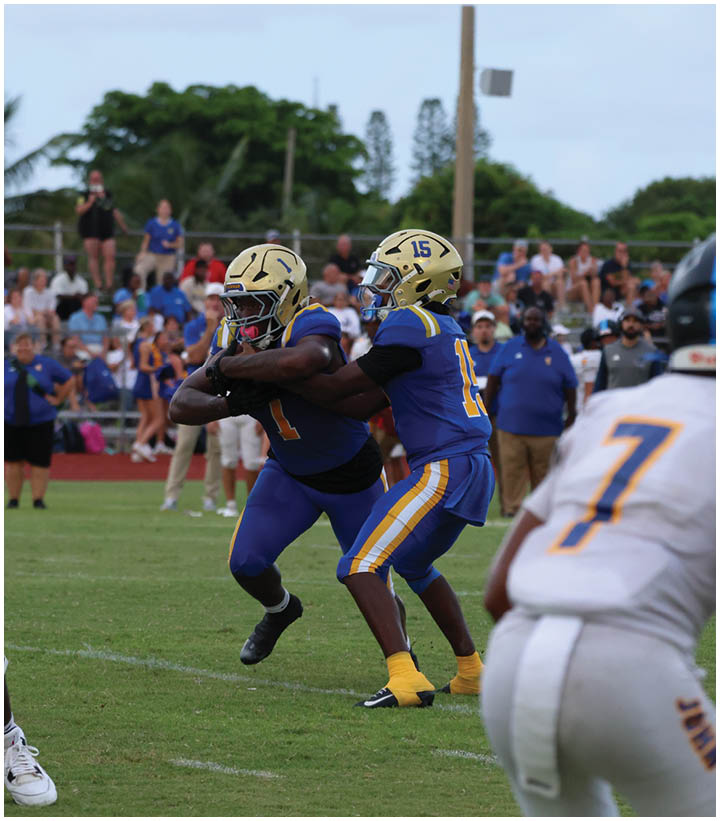 A group of football players wearing black and white uniforms. Description generated by AI