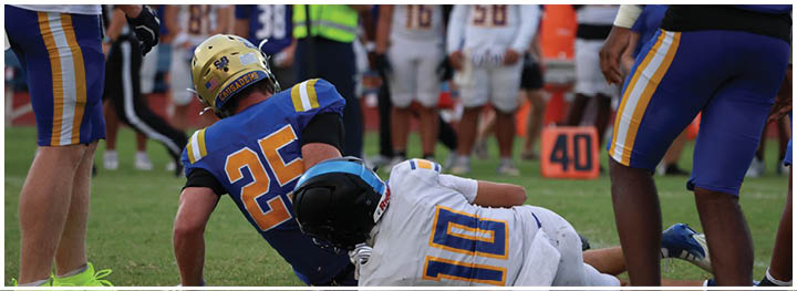 A football player is sliding on the ground. Description generated by AI