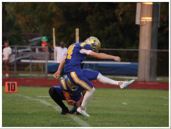 A football player is sliding on the ground. Description generated by AI