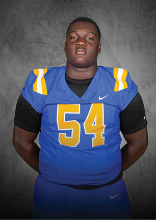 A young man wearing a white and black jersey with the number 14 on it. Description generated by AI