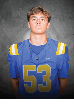 A young man wearing a white and black jersey with the number 14 on it. Description generated by AI