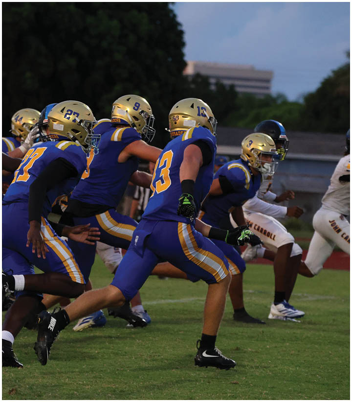 A group of football players wearing black and white uniforms. Description generated by AI