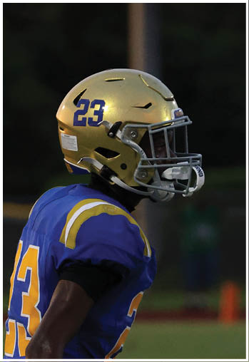 A football player running on the field. Description generated by AI
