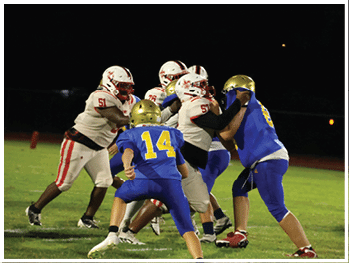 A football player is sliding on the ground. Description generated by AI
