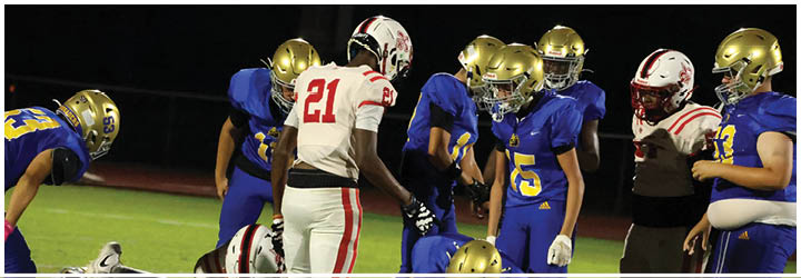 A group of football players on a field. Description generated by AI